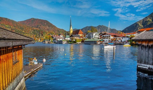 Boathouses at Malerwinkelblick with waterfront of the village, St. Laurentius parish church in