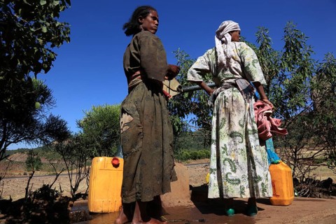Amhara region, locals fetching water from a well, Ethiopia, Africa