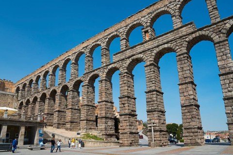 Ancient stone aqueduct in impressive architecture under a blue sky, Aqueduct, Segovia, Castilla y