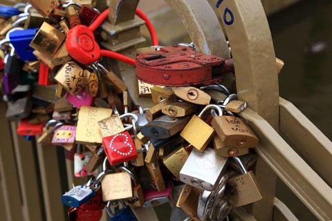 Lover's lock on a railing, love lock is a padlock which, according to custom, is attached to