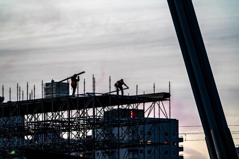 Workers dismantle scaffolding on the Erasmus Bridge over the Nieuwe Maas in Rotterdam, Netherlands