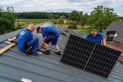 Installation of solar modules on the roof of a barn on a farm, over 240 photovoltaic modules are