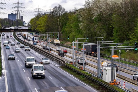 Weighing and barrier system on the A42 motorway, in front of the dilapidated motorway bridge over