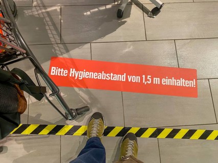 Effects of the corona crisis in Germany, sticker on the floor informs customers of a supermarket