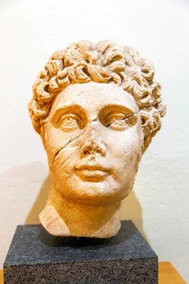 Carved marble Roman portrait head of a young man, archaeology museum, Apollonia Archaeological