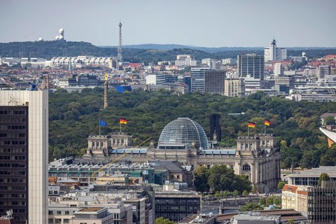 View of Reichstag with German flag, radio tower and ICC trade fair centre. City view. Berlin,