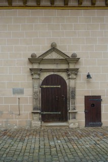Entrance Protestant castle church, gate, wooden door, information board, writing, letters, masonry,