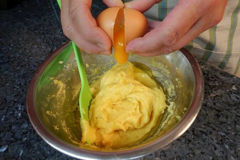Swabian cuisine, preparing choux pastry for mini cream puffs, adding egg to raw choux pastry,