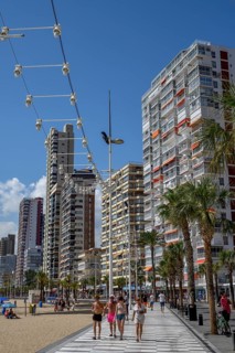 Tourists on the beach promenade at Playa Levante, Benidorm, Alicante province, Costa Blanca, Spain,
