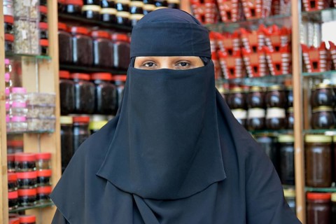 Portrait of a incense seller at her booth on the incense market, Salalah, Dhofar Region, Orient,