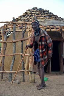 Chief Hikuminue Kapika, chief of the Namibian Himba in front of his hut, Omuramba, Kaokoland,
