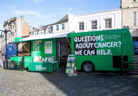 Macmillan Cancer Support green bus in the town centre of Chippenham, Wiltshire, England, United