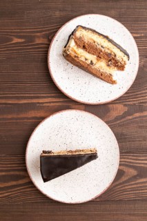 Chocolate biscuit cake with caramel cream on brown wooden background. top view, flat lay