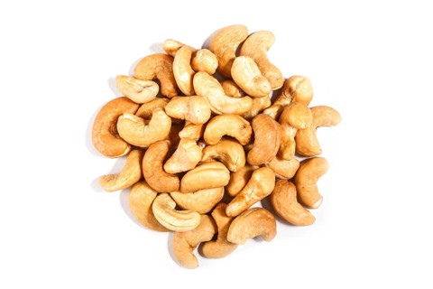 Pile of sweet cashew nuts isolated on white background. Top view