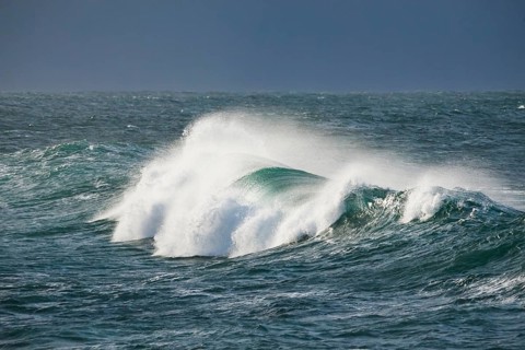 Big wave breaks in the open sea on the Breton coast near Brest, France, Europe