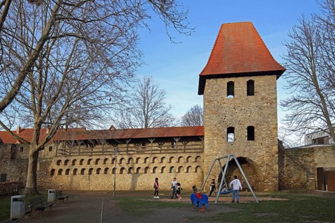Historic town fortifications with pigeon tower and children's playground, town wall with