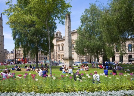 People enjoying summer sunshine on the grass at Orange Grove, Bath, Somerset, England, United