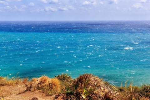 View of turquoise sea, horizon, coastline at La Isleta, sunny weather, typical light mood,