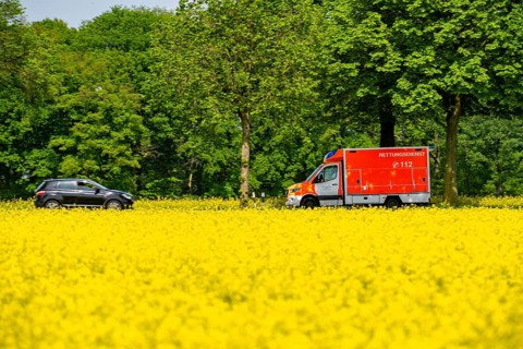 Landscape on the Lower Rhine, ambulance on the B57 federal road between Xanten and Kalkar, road