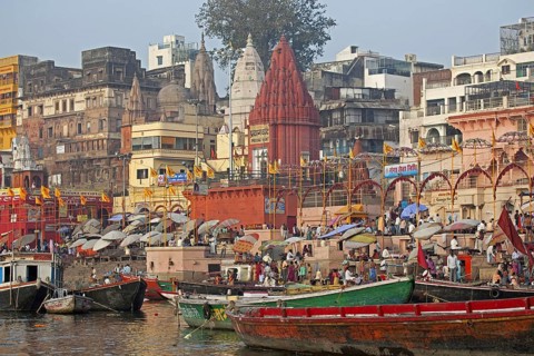 Holy city and colourful rowing boats on the Ganges river at Varanasi, Uttar Pradesh, India, Asia
