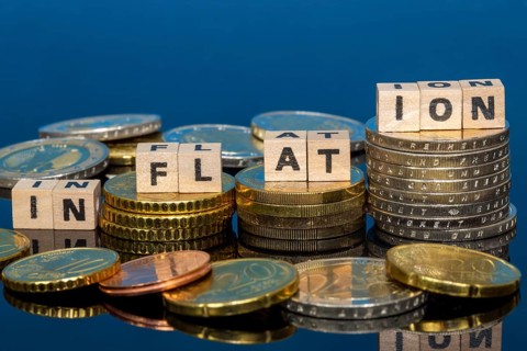 Symbolic image of inflation: euro coins and letters displaying the word INFLATION