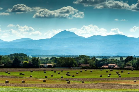 View of the Chain of Volcanoes and Limagne plain under a vibrant sky in Puy-de-Dôme,