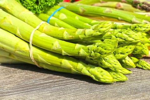Green asparagus decorated on a rustic wooden table