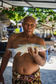 Indonesian fishmonger at a market, fish, man, food, foodstuff, local, travel, long distance,