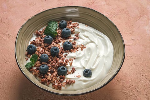 Yogurt with chocolate muesli, with berries, blueberries, breakfast, close-up, fork on top, no