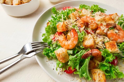 Caesar salad, with shrimp, on a white background, homemade, no people
