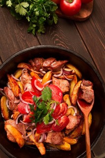 Ojakhuri, Traditional Georgian dish, fried potatoes with meat, in a clay frying pan, top view, no