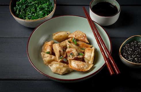 Japanese fried gyoza dumplings, with pork, sesame seeds, green onions