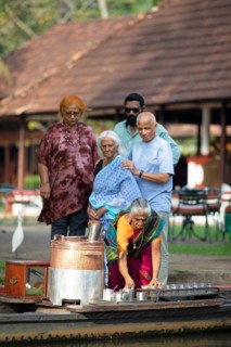 Tealady, 83 years old, making Indian tea on her boat, Backwaters, Kumarakom, Kerala, India, Asia