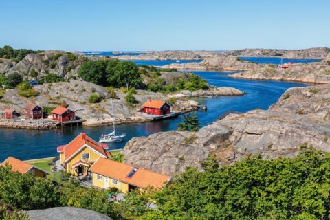 View of a rocky archipelago with boats and houses on the Swedish west coast on a beautiful summer
