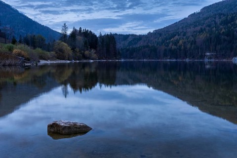 Lake Schwarzensee in autumn. Trees in autumn leaves. Blue hour. Reflection. St. Wolfgang,