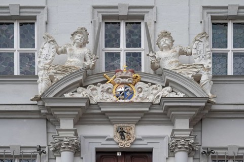Entrance potal with sculptures and coat of arms of the baroque town hall, built in 1718, Iphofen,