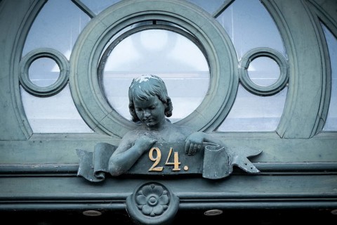 Detail of a historic door with bust of a girl and house number 24, Borups Højskole, school