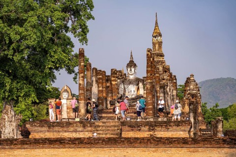 Tourists in the central Buddhist temple Wat Mahathat, UNESCO World Heritage Sukhothai Historical