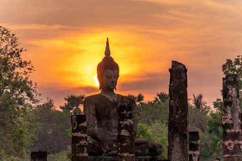 Sunset at a Buddha statue of the temple Wat Mahathat, UNESCO World Heritage Sukhothai Historical