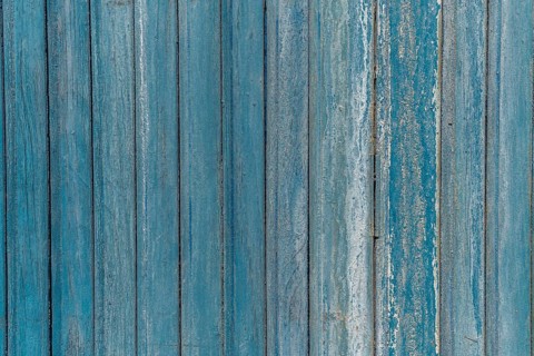 Garage door boards stained blue with worn paint. Brittany France