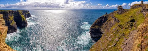Panoramic views of majestic cliffs and sparkling sea under sunny skies, Cliffs of Moher