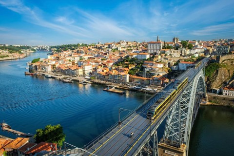 View of Porto city and Douro river and Dom Luis bridge I with metro tram from famous tourist