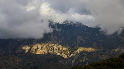 Mountain landscape with clouds and partly sunny rocks casting shadows, Lefka Ori, White Mountains,