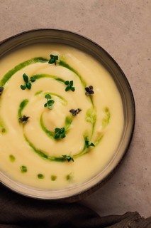 Mashed potatoes, with green butter and micro greenery, homemade, on a beige table, no people, top