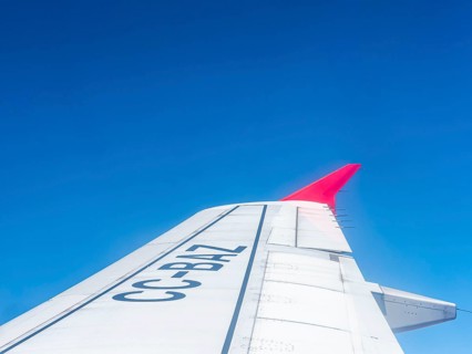 Wing aeroplane with red tip, blue sky