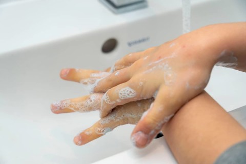 Domestic hygiene, washing hands, with a bar of soap, boy 9 years old