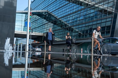 Cyclists on the cycle path on Christians Brygge Street, at the Black Diamond, Danish Royal Library,