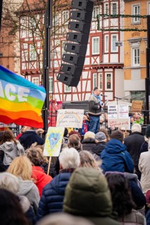 Demonstration with speaker and rainbow flag for peace and diversity, demonstration against the