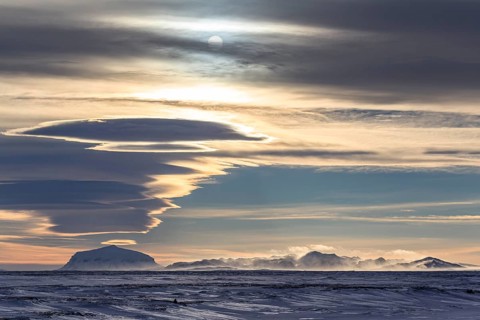 Snowy mountains against the light, cloudy mood, sunny, windy, view of Herdubreid, North Iceland,