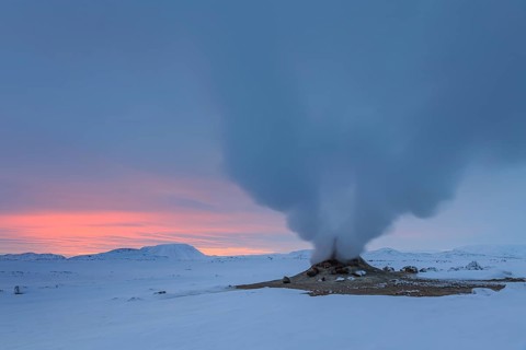 Hot springs and geothermal area in front of a mountain landscape in winter, cloudy mood, Hverir,
